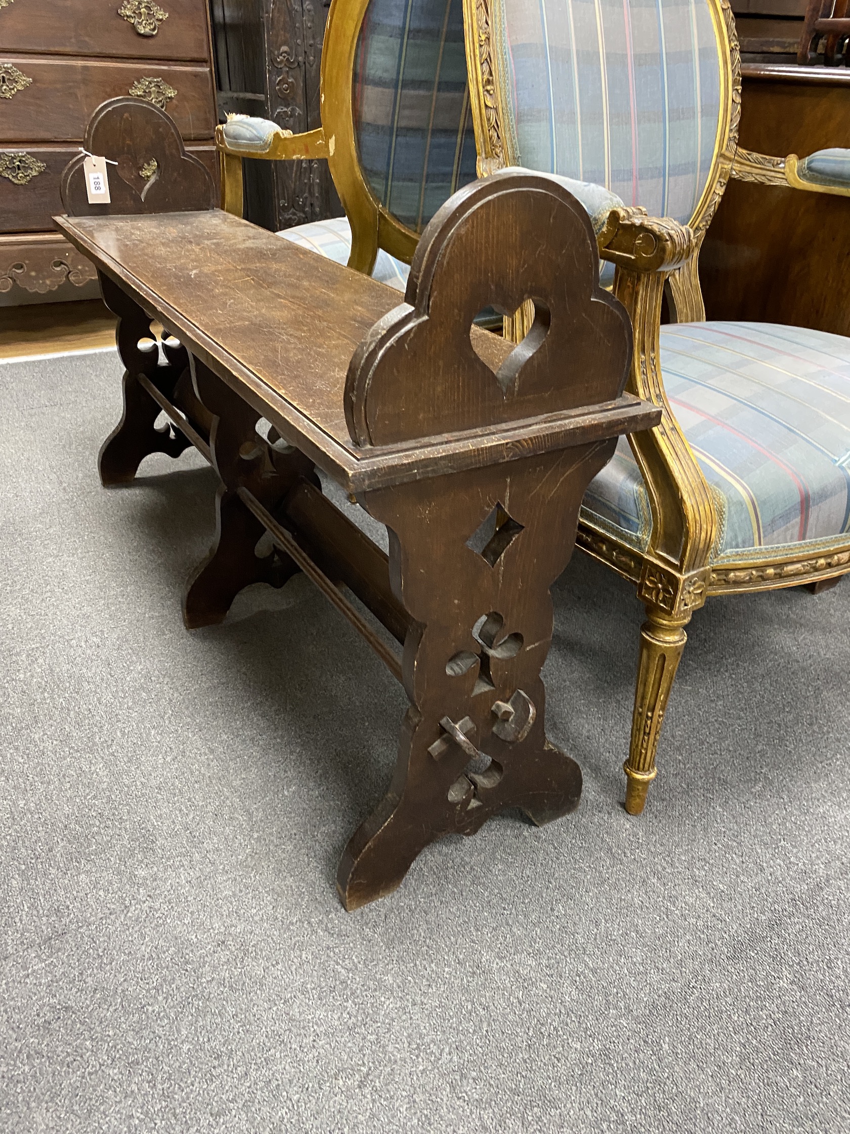 A late Victorian Gothic revival oak window seat, width 118cm, depth 30cm, height 69cm